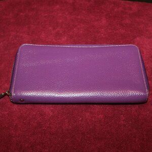 Lavemi purple leather look wallet with a zip-around closure